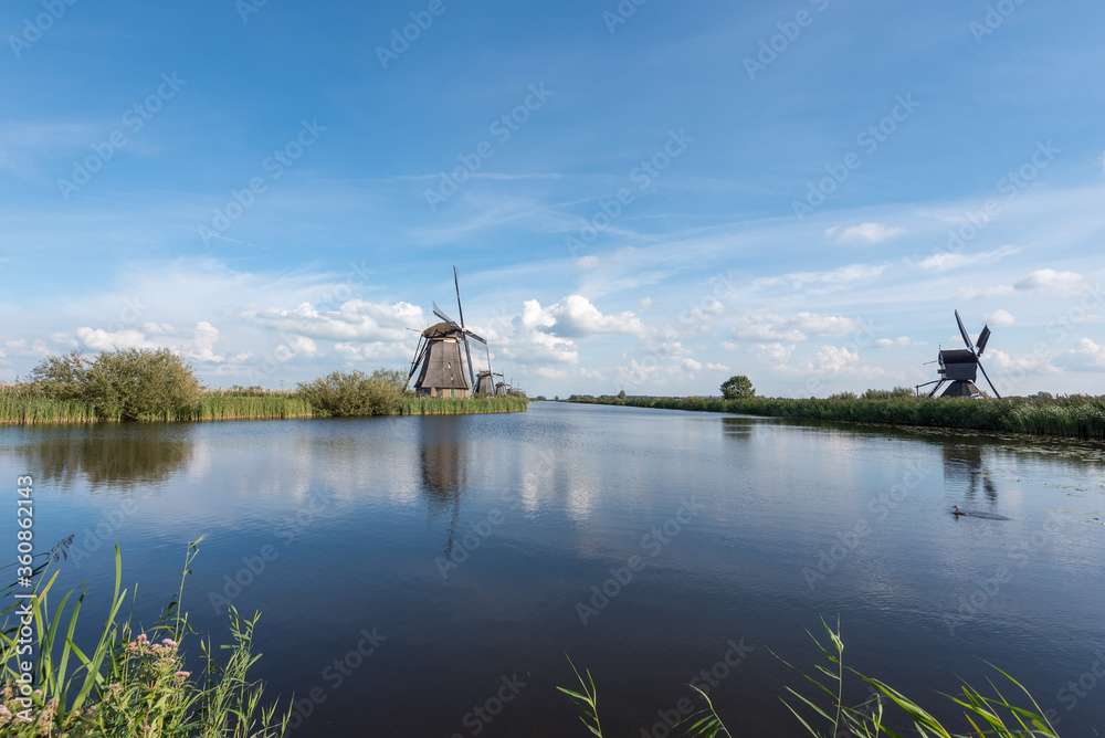 windmills in the netherlands along a canal