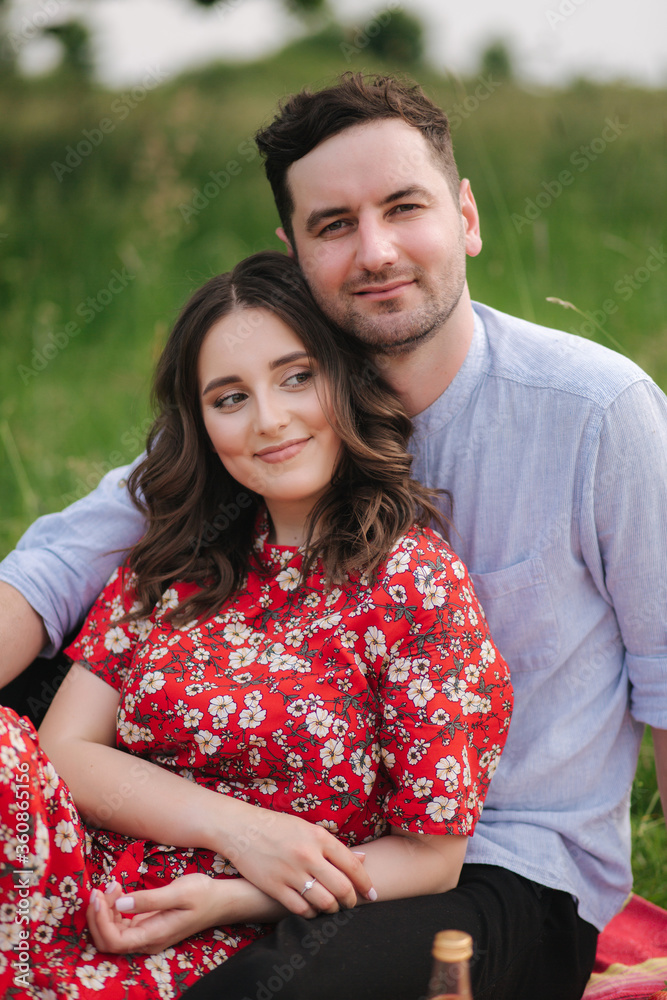 Portrait of beautiful man and woman sitting outdoors Portrait of beautiful man and woman sitting outdoors