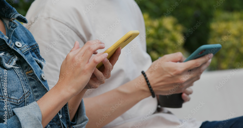 Friends use of cellphone at outdoor