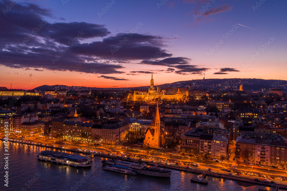Aerial drone of lighted Matthias Church on Buda hill during Budapest sunset