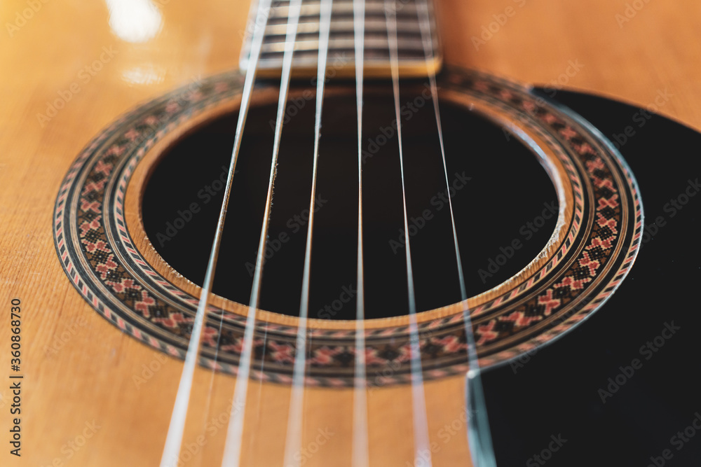 Closeup detail of classical guitar with nylon strings. Closeup detail of classical guitar with nylon strings.