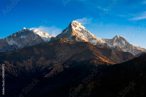Nature view of Himalayan mountain range at Poon hill view point,Nepal. Poon hill is the famous view point in Gorepani village to see beautiful sunrise over Annapurna mountain range in Nepal © ChomchoeiFoto