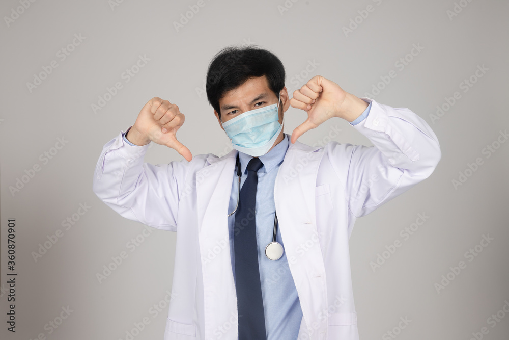 Doctor wear mask protect and showing hand dislike before working in clean laboratory for test coronavirus vaccines. An experiment to produce a vaccine for the treatment of disease in an aseptic lab. Doctor wear mask protect and showing hand dislike before working in clean laboratory for test coronavirus vaccines. An experiment to produce a vaccine for the treatment of disease in an aseptic lab.