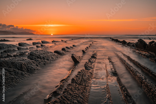 The incredible Flysch, a beautiful sunset in Sakoneta, is a beach in Deba. It is the western end of the Geopark of the Basque Coast, Guipuzkoa, Basque Country. Long exposition