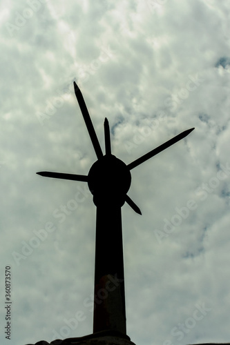 Silhouette of a lightening conductor against day sky