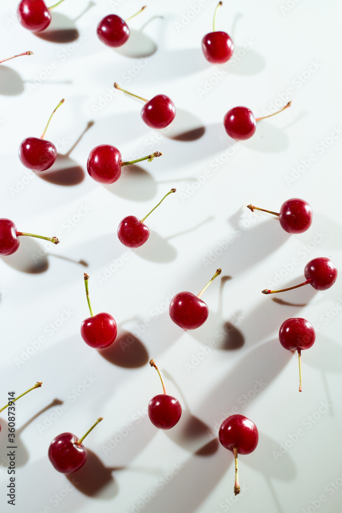 Group of cherry on a white background with shadows. Close-up. Top view. Group of cherry on a white background with shadows. Close-up. Top view.