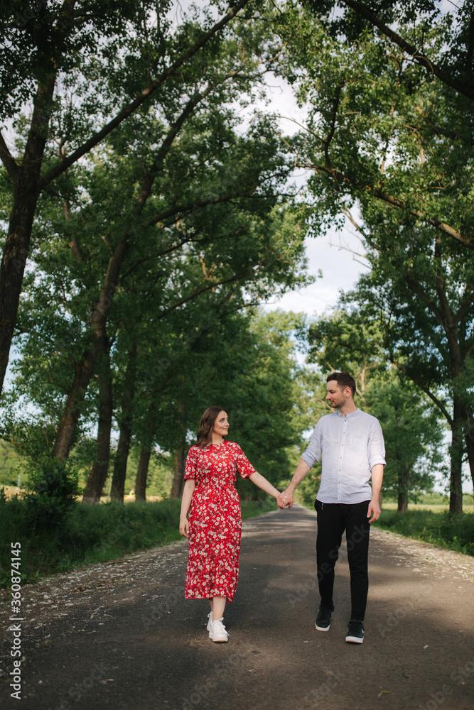 Beautiful couple walking in park. Happy young female with handsome man Beautiful couple walking in park. Happy young female with handsome man