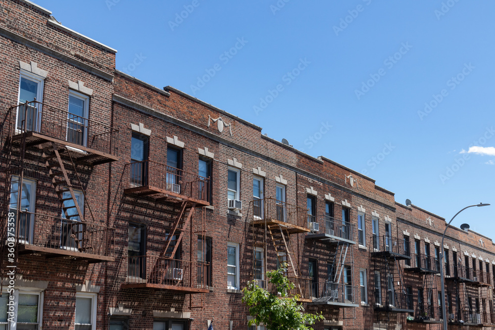 Row of Old Brick Residential Buildings with Fire Escapes in Sunnyside Queens New York