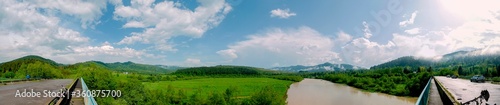 Stormy water of a mountain muddy river when it falls on the plain (clean before flooding). River after summer rains in the mountains, clay-colored water