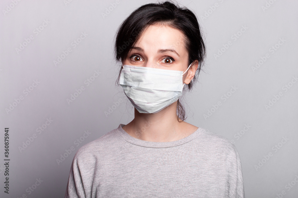 woman in medical mask, closeup portrait, gray studio background woman in medical mask, closeup portrait, gray studio background