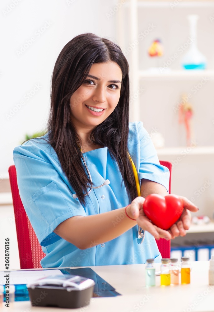 Young beautiful female doctor working in the clinic Young beautiful female doctor working in the clinic