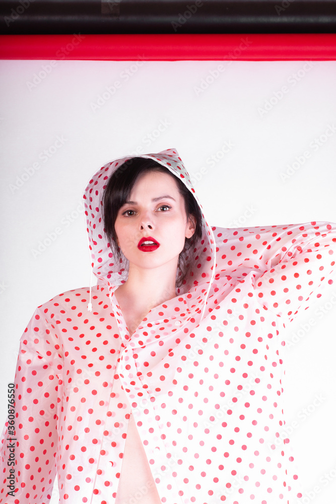 fashionable woman with red lips in a raincoat fashionable woman with red lips in a raincoat