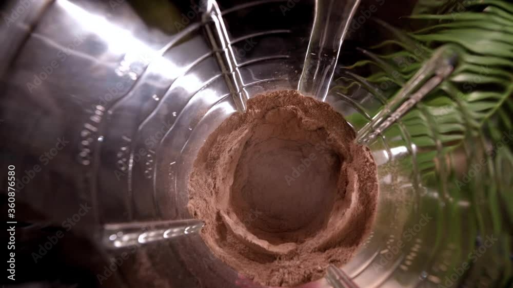 Cocoa powder is blended in blender. Wide angle. Top view. Closeup