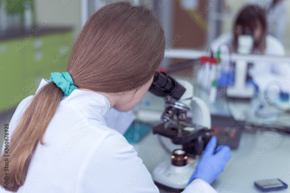 Group of Laboratory scientists working at lab with test tubes, test or research in clinical laboratory.Science, chemistry, biology, medicine and people concept. Group of Laboratory scientists working at lab with test tubes, test or research in clinical laboratory.Science, chemistry, biology, medicine and people concept.
