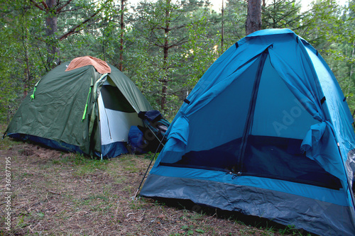 Two tourist tents in the forest. Tourist vacation in the wild.