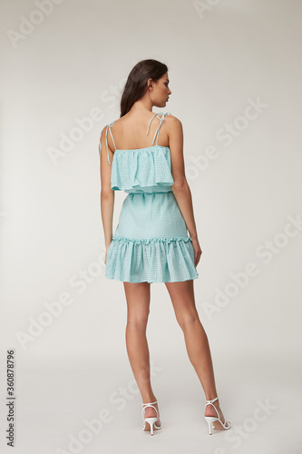 Woman beautiful face natural make up brunette hair tanned skin body wear fashion summer collection organic cotton lace short  dress style for romantic date walk, accessory and shoes sandals clothes.