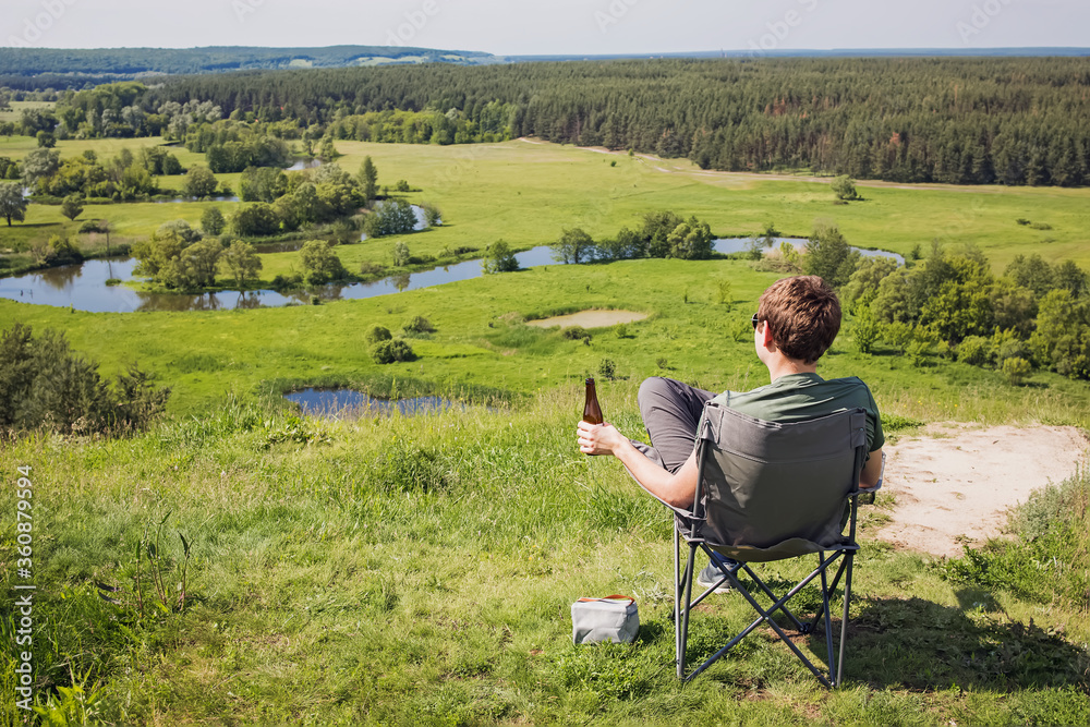 Man resting in a camping chair with beautiful view