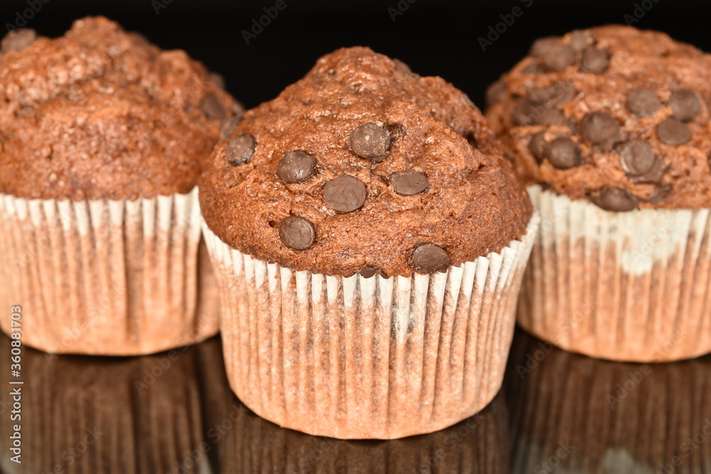 Chocolate muffins, close-up, on a black background.