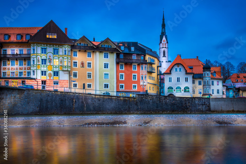 BAD TOLZ, GERMANY - Evening View of the Colorful Houses in the Old Town Center of Bad Tolz, with Reflections in the Isar River photo