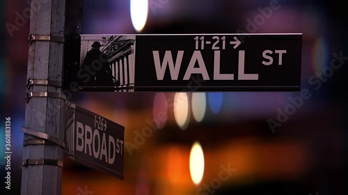 City lights defocused behind the wall street signpost in lower Manhattan, New York City, USA. photo