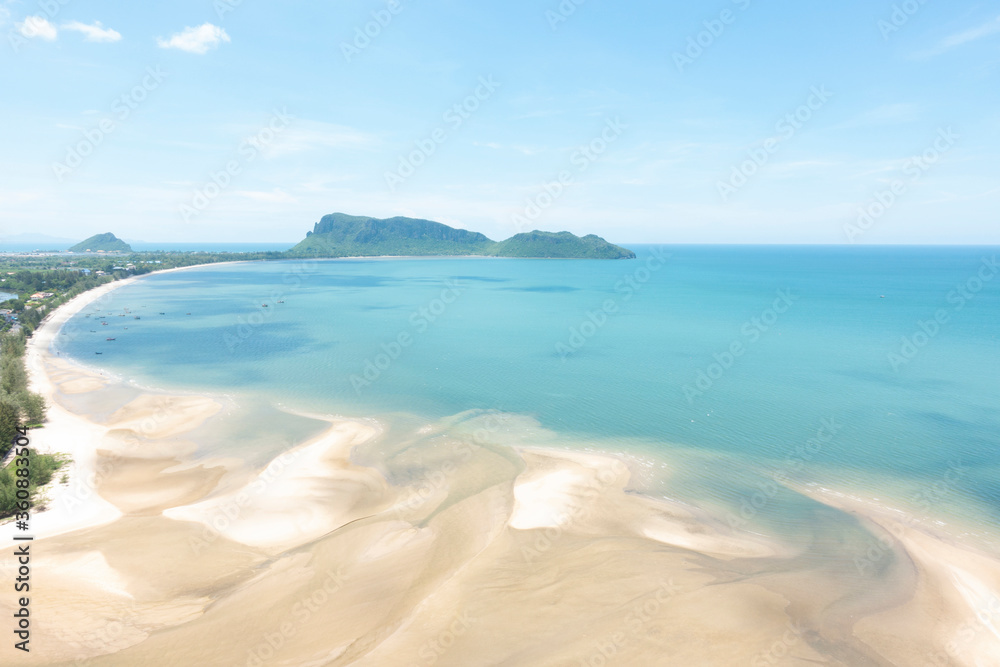 Sea and beach with blue sky background on a calm day.
