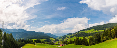 Beautiful Alpine valley between the mountains with blue cloudy sky