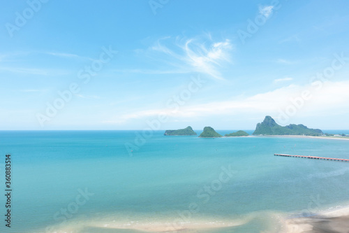 Sea and beach with blue sky background on a calm day.