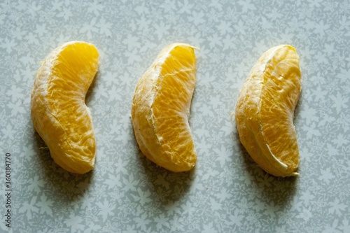 three orange slices on a light background