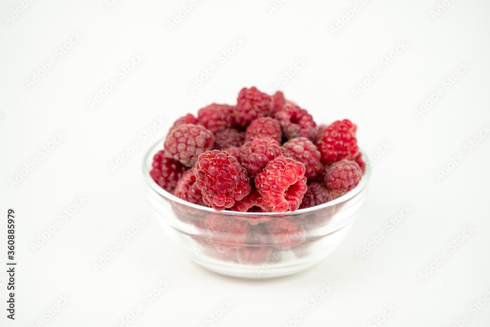fresh ripe raspberry in a glass transparent bowl on white background fresh ripe raspberry in a glass transparent bowl on white background