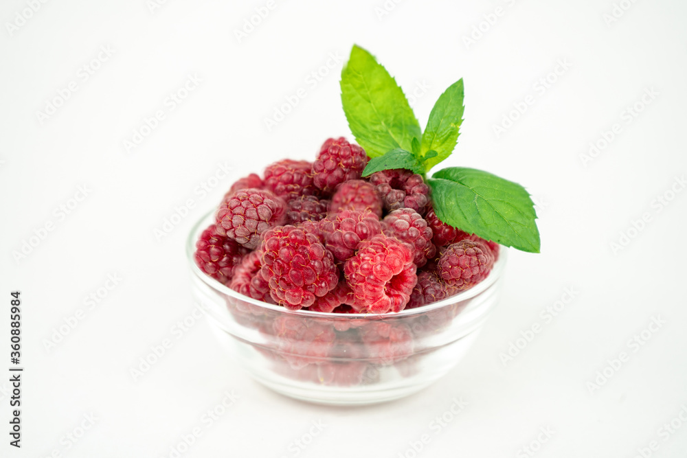 fresh ripe raspberry in a glass transparent bowl on white background fresh ripe raspberry in a glass transparent bowl on white background