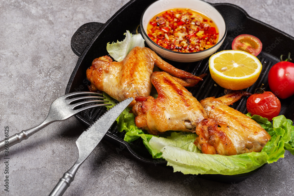 Delicious grilled chicken wings and vegetable salad Delicious grilled chicken wings and vegetable salad