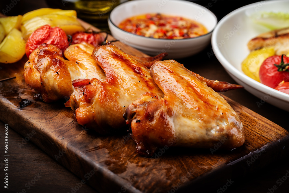Delicious grilled chicken wings and vegetable salad Delicious grilled chicken wings and vegetable salad