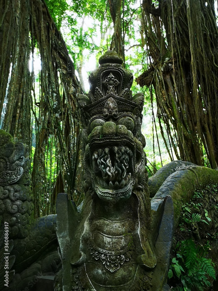 Dragon carving in a stone bridge abutment within the Monkey Forest at Ubud, Indonesia