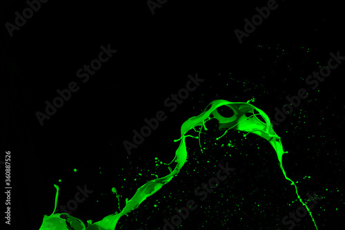 Shot of green paint splash, isolated on black background