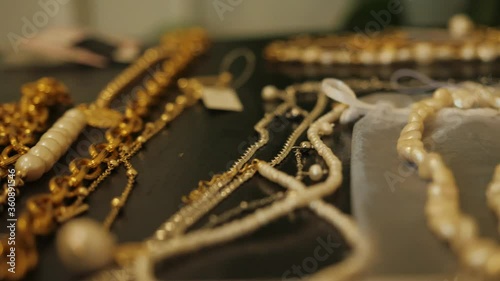 Several pieces of jewelry and necklaces were spread out on the table.