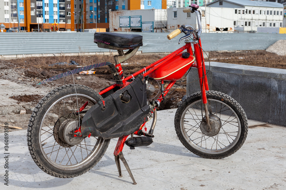Restored Bicycle with a motor, red moped, manufactured in the Soviet Union
