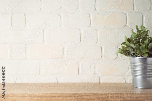 Fényképezés Empty wooden shelf with plant over brick wall interior