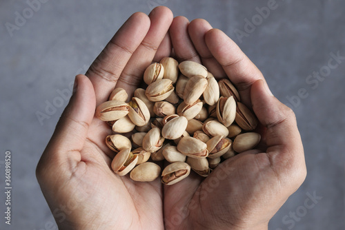 close up of pistachios nut on hand 
