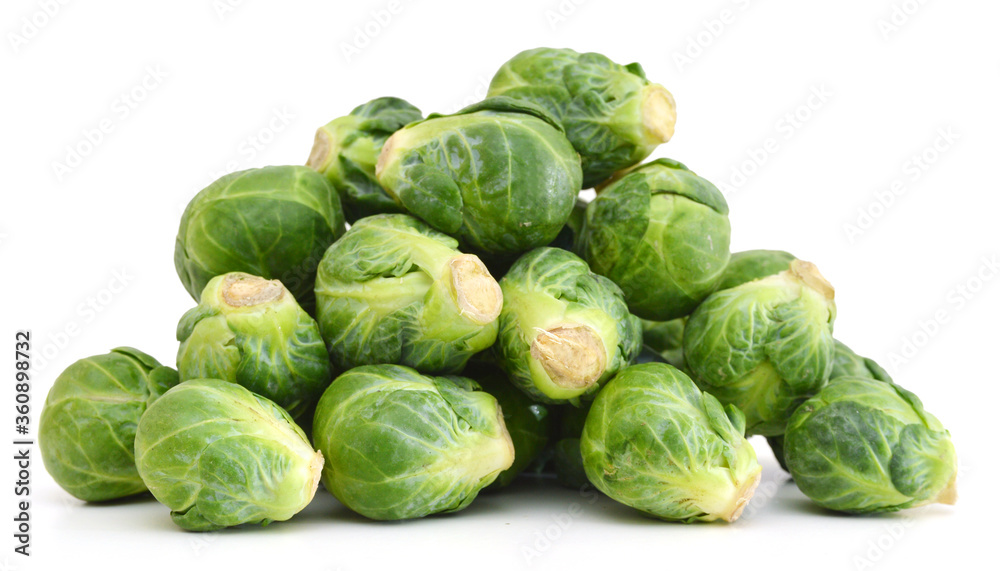 freshly brussel sprouts and some whole ones on a white background freshly brussel sprouts and some whole ones on a white background