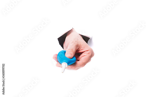 male hand with a mudic air pear through a hole in paper on isolate white background. close, copy space. photo