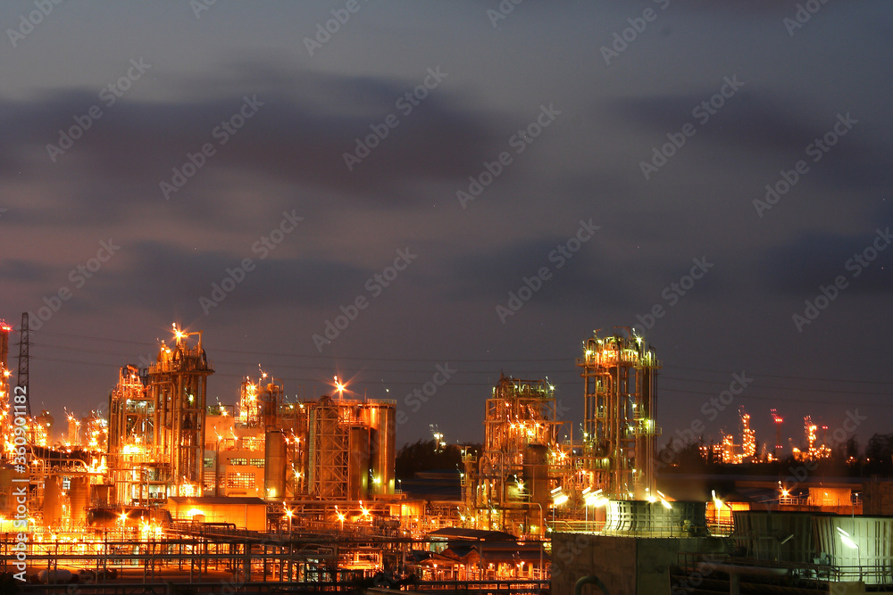 Fototapeta premium The light of a petrochemical factory that is normally produced on nights with full stars.