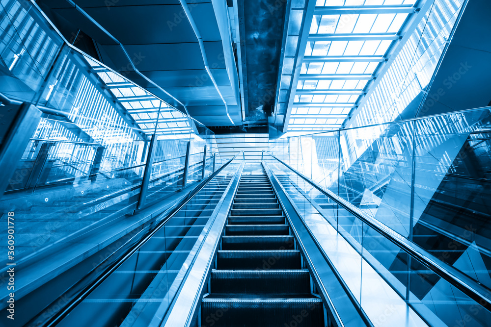 The escalator is in the mall The escalator is in the mall