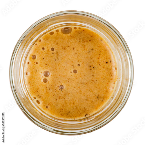 Honey with sea buckthorn in a glass jar. Isolated on a white background. View from the top.