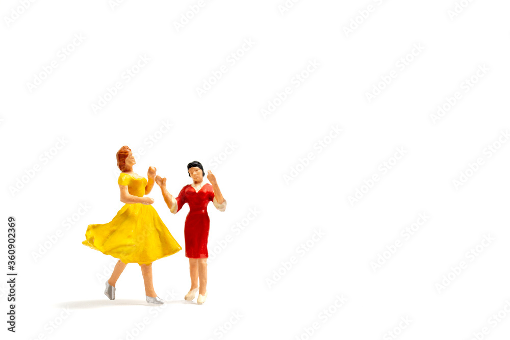 Miniature people Lesbian couple dancing on white background , Homosexual Relationship concept