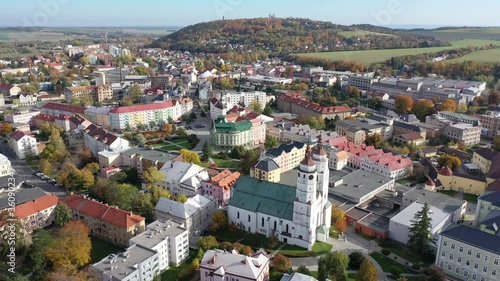 Panoramic aerial view of autumn landscape of Czech town of Krnov with white building of St. Martin church and Town hall on main square on sunny day, Moravian-Silesian Region photo