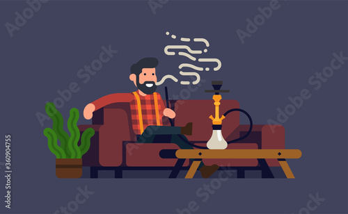 Man sitting on couch relaxing and smoking hookah or shisha