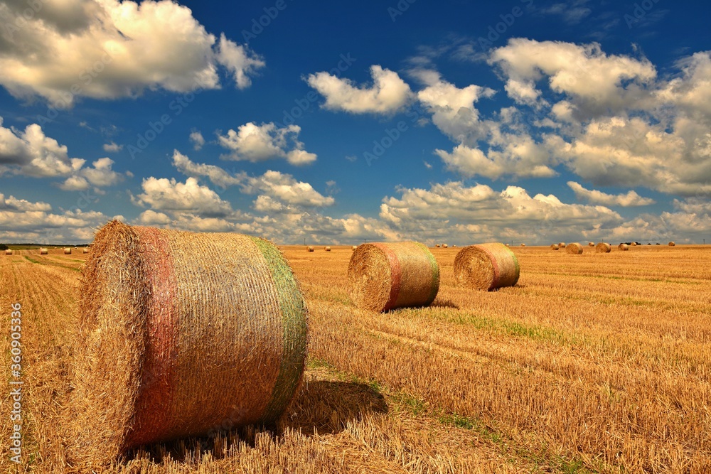 Beautiful countryside landscape. Hay bales in harvested fields. Czech Republic - Europe. Agricultural background - harvest.