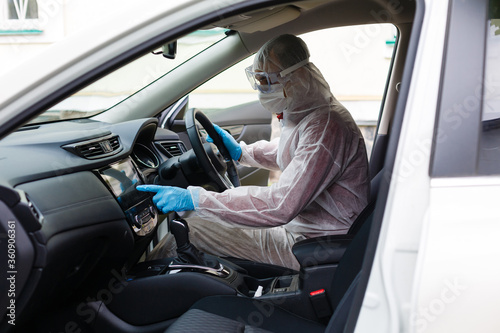 Hot steam disinfection of car seats in coronavirus hazmat  copy space for text
