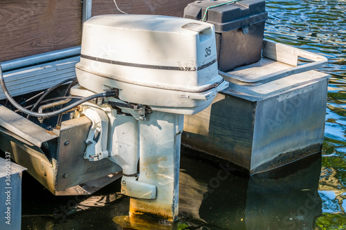 Slika na platnu An old 35 HP outboard motor attached to an old pontoon boat