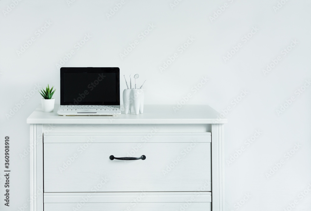Dentist table with laptop and teeth model. Computer on dentist table, template for design. Dentist table with laptop and teeth model. Computer on dentist table, template for design.